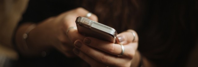 Hands holding a cell phone